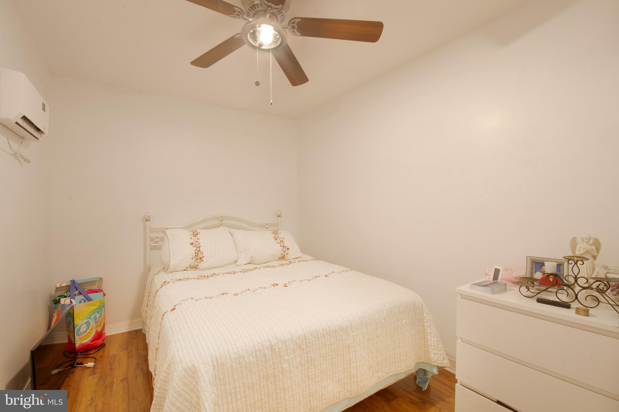7 Gainor Road New Castle, DE 19720 - Photo 16 of 27 a bedroom with a bed and a chandelier