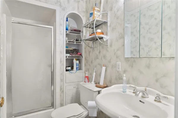 a bathroom with a sink toilet and shower