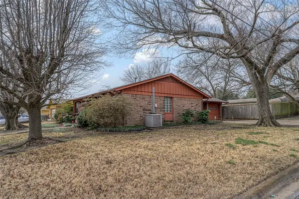 a house that has a tree in front of it