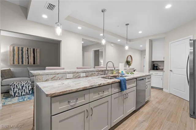 a kitchen with a sink stove and refrigerator