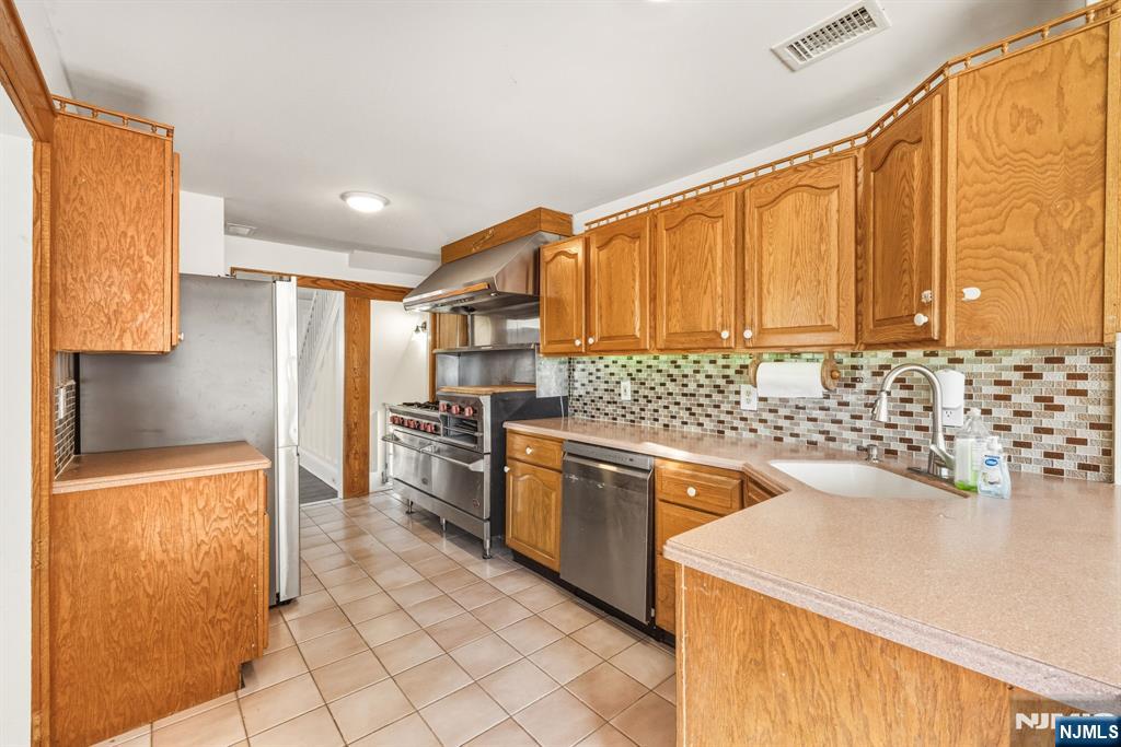331 Mountain Way Rutherford, NJ 07070 - Photo 12 of 45 a kitchen with stainless steel appliances granite countertop a sink and a refrigerator