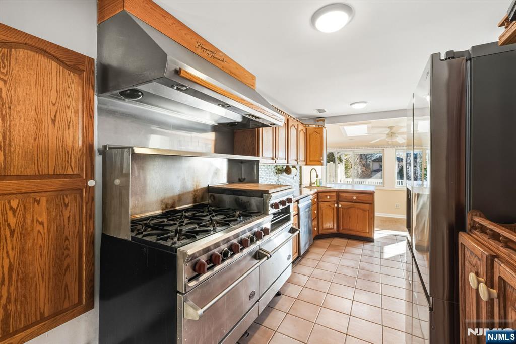 331 Mountain Way Rutherford, NJ 07070 - Photo 13 of 45 a kitchen with stainless steel appliances granite countertop a stove a refrigerator and a wooden cabinets