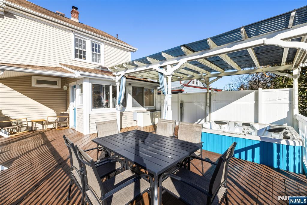 331 Mountain Way Rutherford, NJ 07070 - Photo 17 of 45 a view of a patio with table and chairs with wooden floor