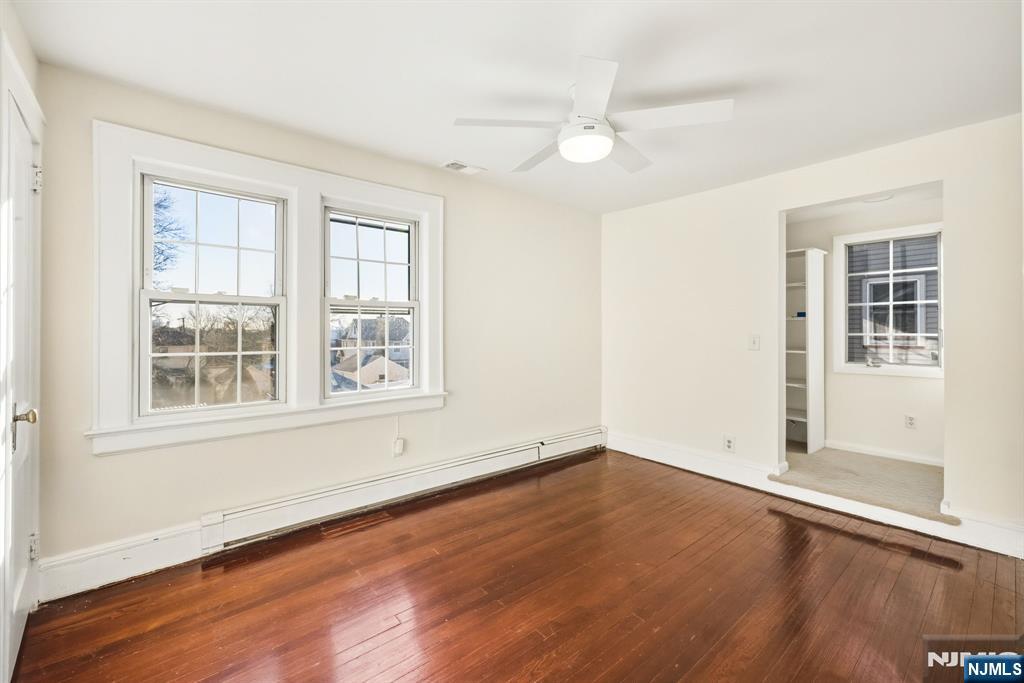 331 Mountain Way Rutherford, NJ 07070 - Photo 19 of 45 an empty room with wooden floor and windows