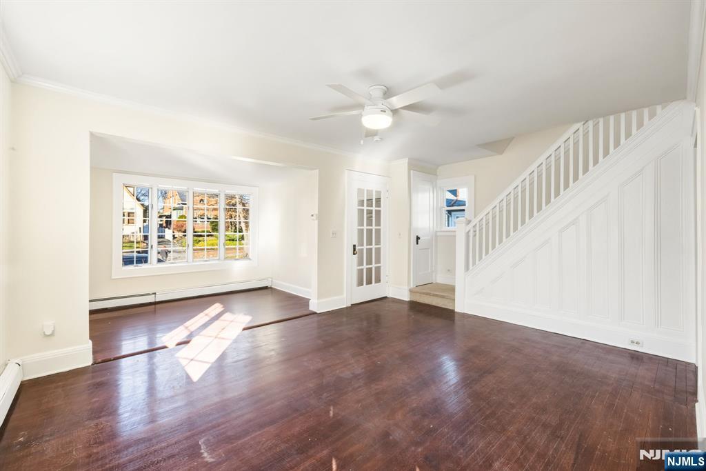 331 Mountain Way Rutherford, NJ 07070 - Photo 2 of 45 a view of an empty room with wooden floor and a window