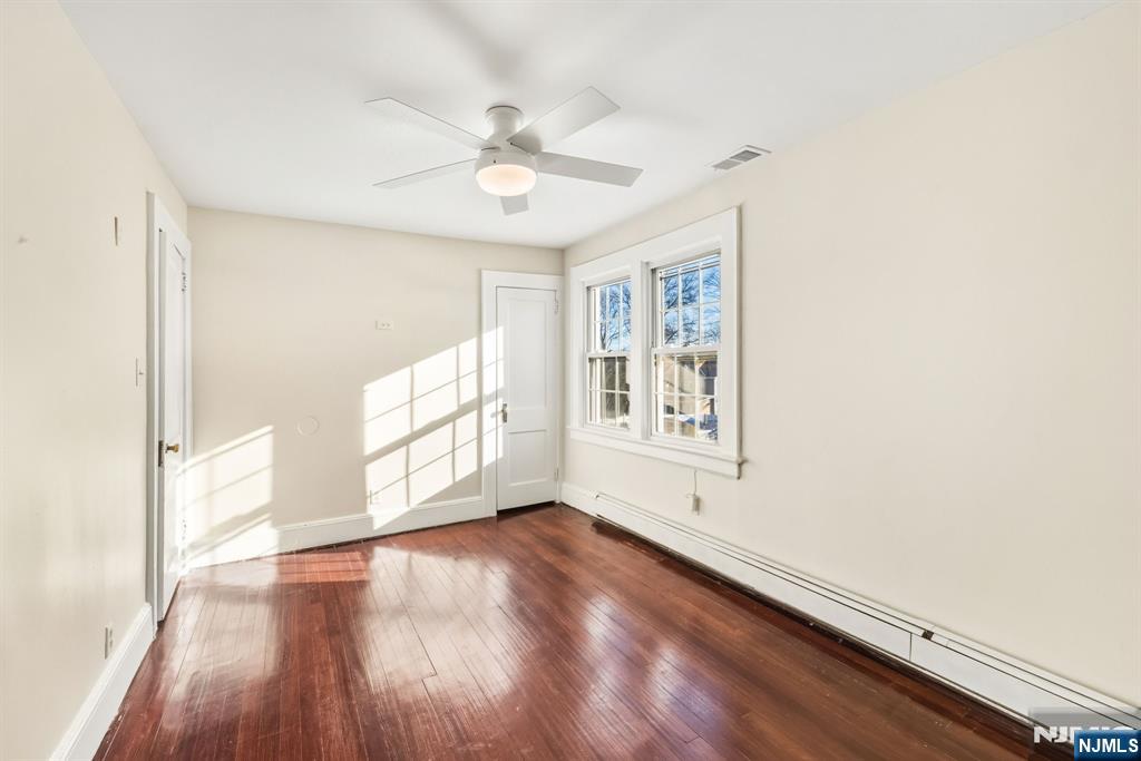 331 Mountain Way Rutherford, NJ 07070 - Photo 21 of 45 an empty room with wooden floor fan and windows