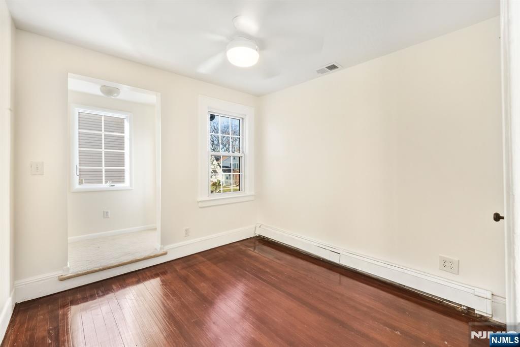 331 Mountain Way Rutherford, NJ 07070 - Photo 22 of 45 an empty room with wooden floor and windows