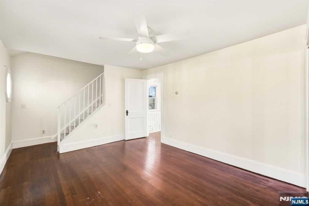 331 Mountain Way Rutherford, NJ 07070 - Photo 24 of 45 a view of an empty room with wooden floor and a ceiling fan