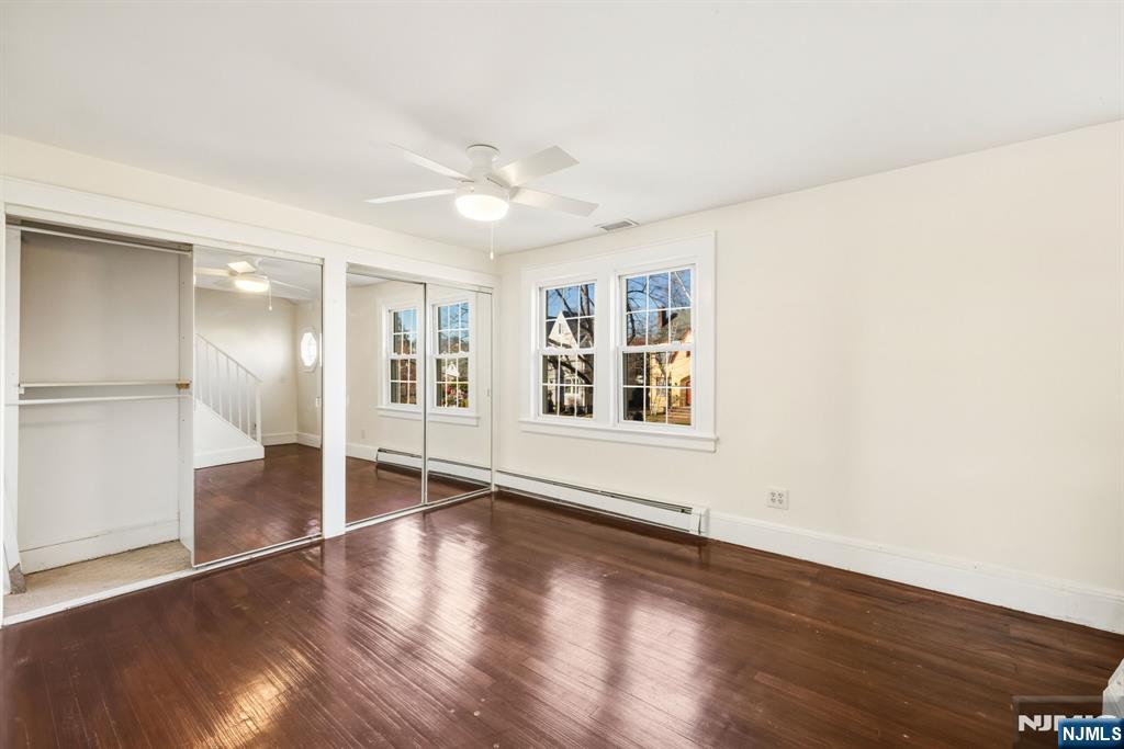 331 Mountain Way Rutherford, NJ 07070 - Photo 25 of 45 an empty room with wooden floor and windows