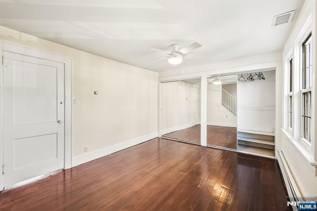 331 Mountain Way Rutherford, NJ 07070 - Photo 26 of 45 an empty room with wooden floor closet and windows
