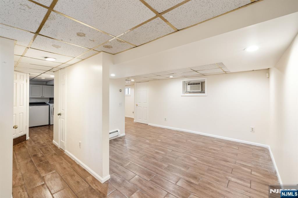 331 Mountain Way Rutherford, NJ 07070 - Photo 31 of 45 a view of a hallway with wooden floor and a kitchen