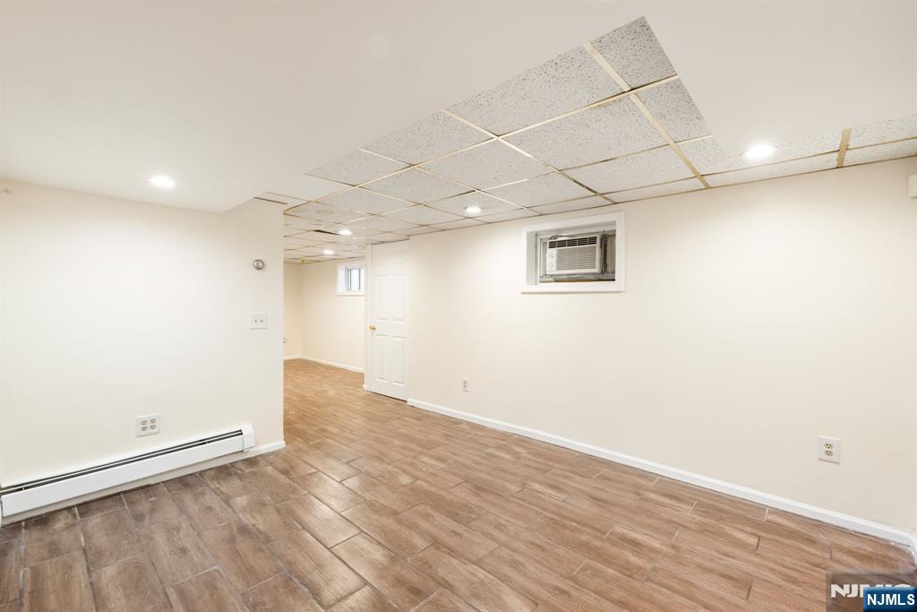 331 Mountain Way Rutherford, NJ 07070 - Photo 33 of 45 an empty room with wooden floor and windows