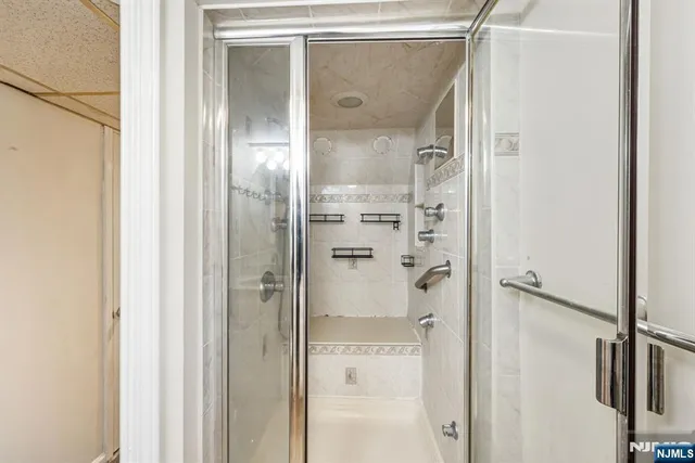 a bathroom with a glass shower door