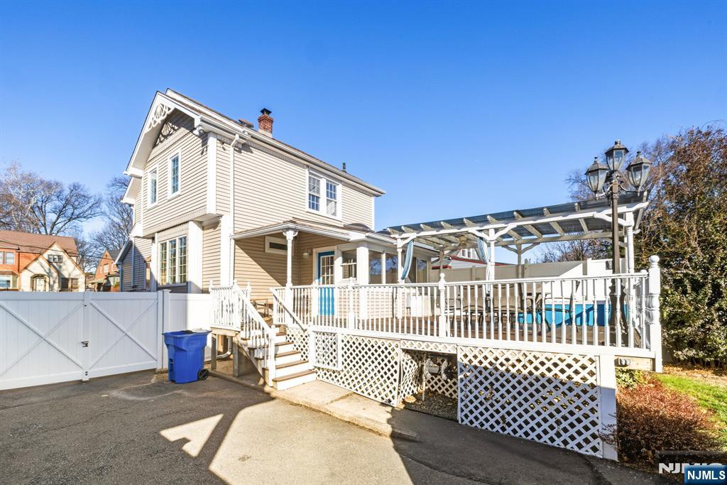 331 Mountain Way Rutherford, NJ 07070 - Photo 39 of 45 a view of a brick house with a wooden bench and floor to ceiling window