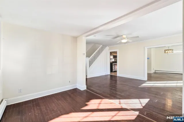a view of an empty room and wooden floor