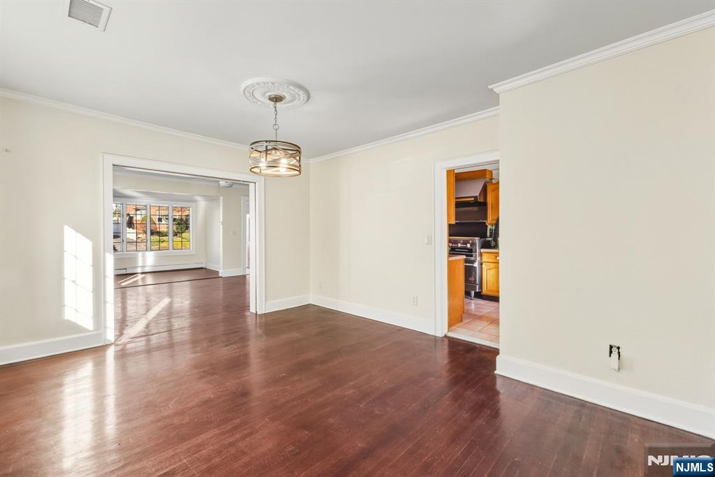 331 Mountain Way Rutherford, NJ 07070 - Photo 10 of 45 a view of an empty room with a window and wooden floor