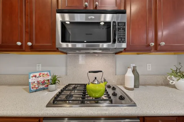 a bathroom with a bathtub shower sink vanity mirror and toilet