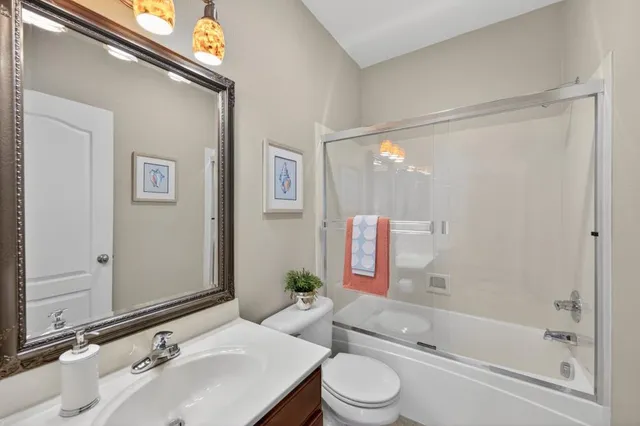 a large living room with stainless steel appliances granite countertop a couch and a flat screen tv