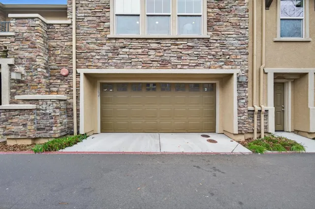 a front view of a house with garage