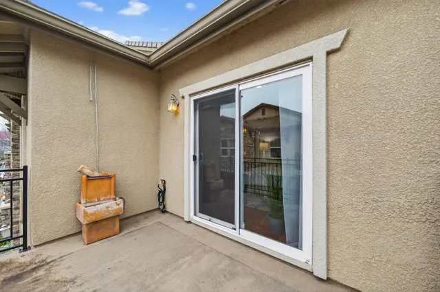 a view of a swimming pool with a patio and a yard