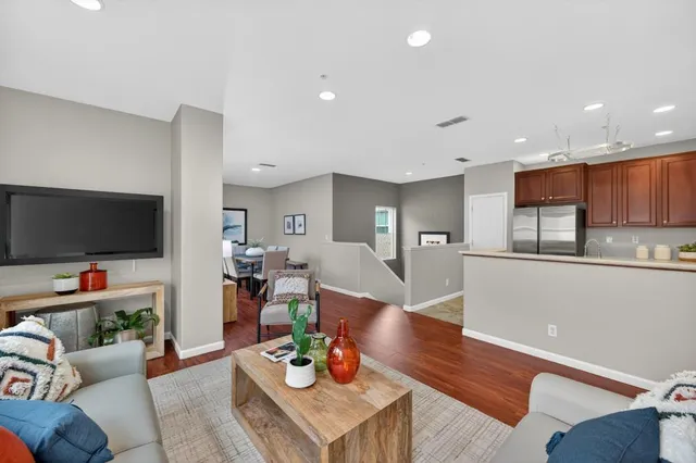 a kitchen with stainless steel appliances granite countertop a sink a stove a refrigerator a microwave and cabinets