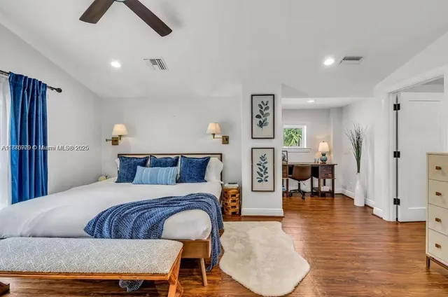 a bedroom with furniture and a wooden floor
