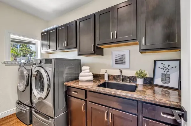 a kitchen with stainless steel appliances granite countertop a sink and cabinets