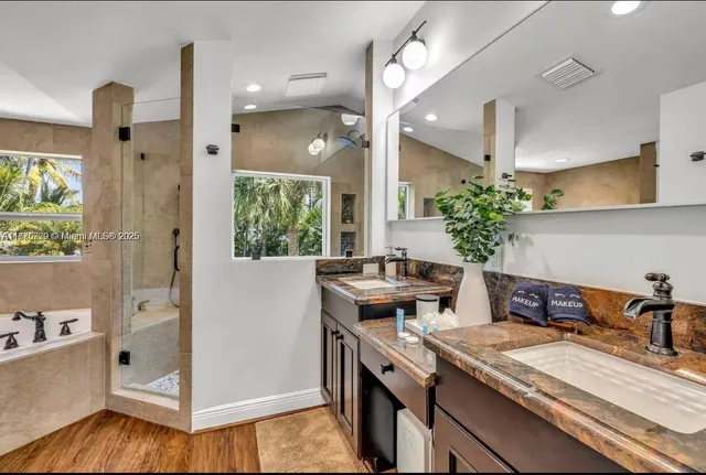 a kitchen with granite countertop a sink and a stove