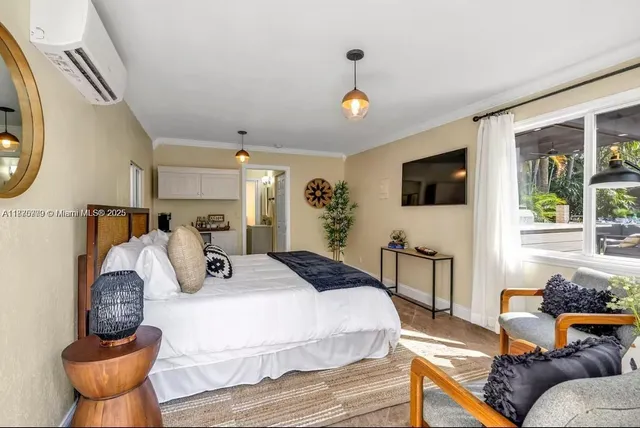 a bedroom with furniture and a flat screen tv