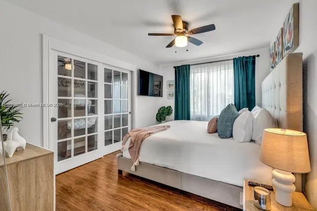 a bedroom with a bed mirror and window