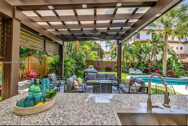 a swimming pool with outdoor seating and yard