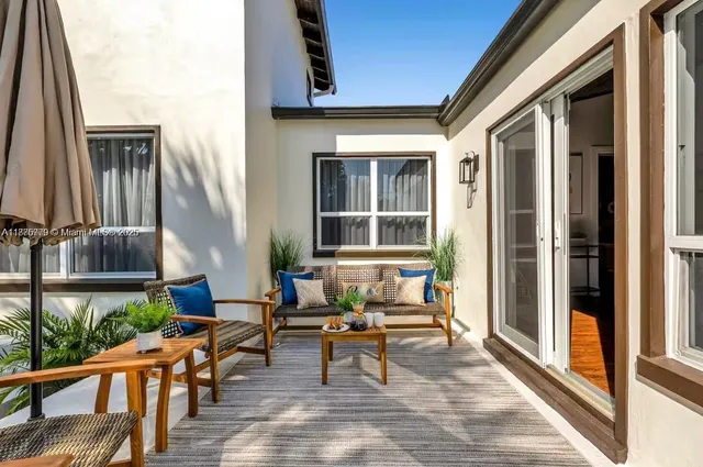 a view of a chair and table under an umbrella