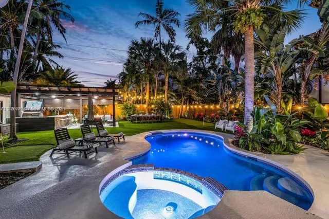 a view of a backyard with furniture and a grill
