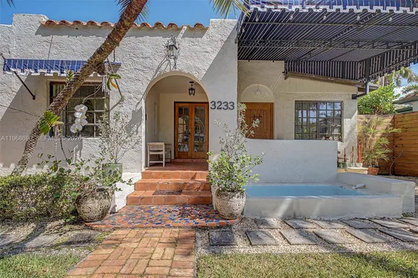 a front view of a house with garden