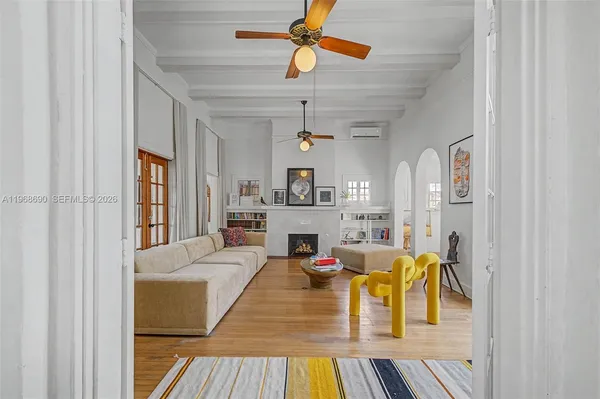 a living room with fireplace furniture and a chandelier
