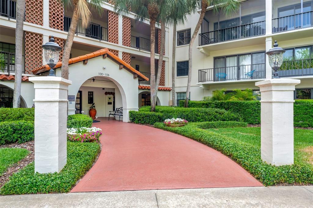 100 South Interlachen Avenue, Unit 410F Winter Park, FL 32789 - Photo 1 of 38 a front view of a house with a yard and potted plants