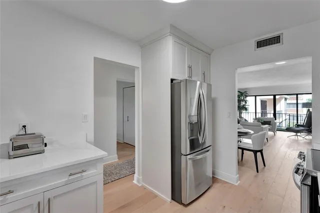 a kitchen with a refrigerator a stove and a sink
