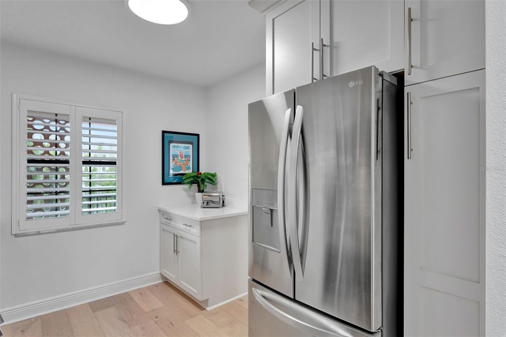 100 South Interlachen Avenue, Unit 410F Winter Park, FL 32789 - Photo 15 of 38 a white refrigerator freezer sitting inside of a kitchen