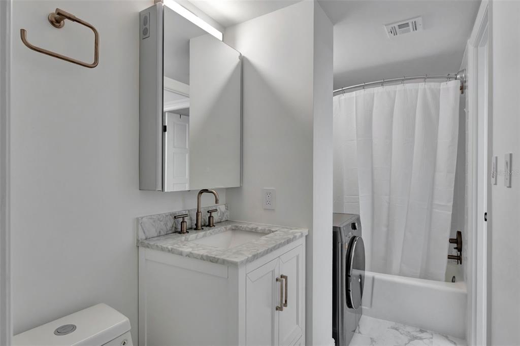 100 South Interlachen Avenue, Unit 410F Winter Park, FL 32789 - Photo 21 of 38 a bathroom with a granite countertop sink toilet and shower