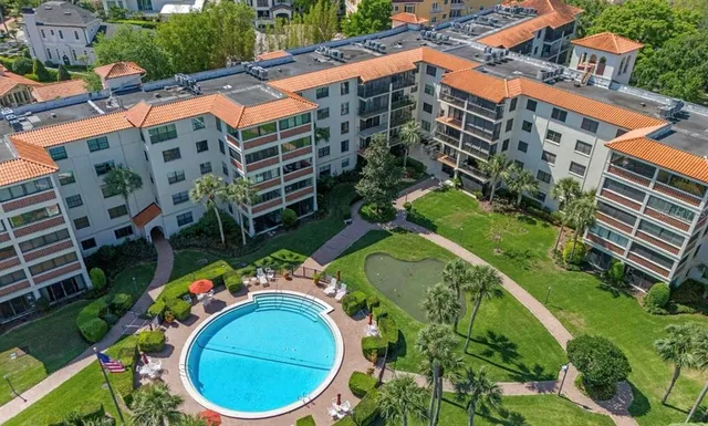 aerial view of a house with a yard and plants