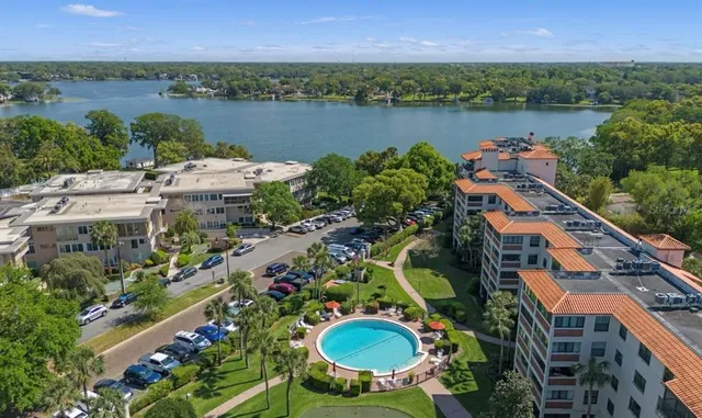 an aerial view of a house with outdoor space and lake view
