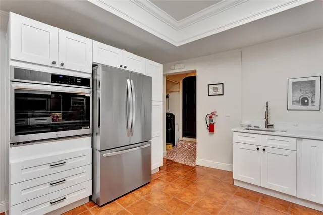 a kitchen with stainless steel appliances a refrigerator stove and cabinets