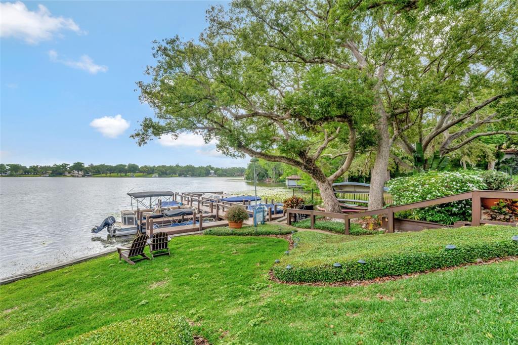 100 South Interlachen Avenue, Unit 410F Winter Park, FL 32789 - Photo 35 of 38 a garden view with a seating space and a bench