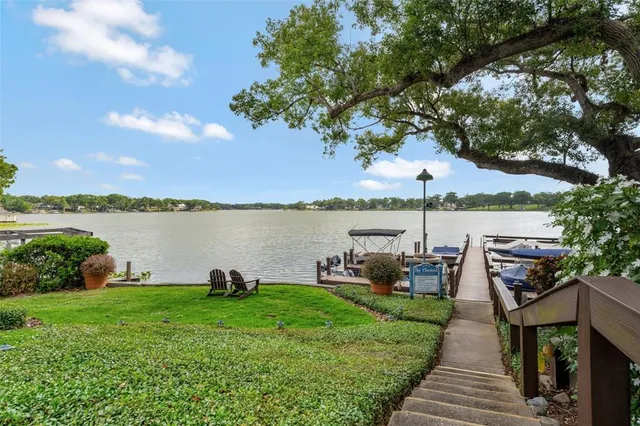 a lake with houses in back