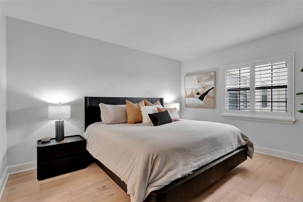 100 South Interlachen Avenue, Unit 410F Winter Park, FL 32789 - Photo 4 of 38 a bedroom with bed and window