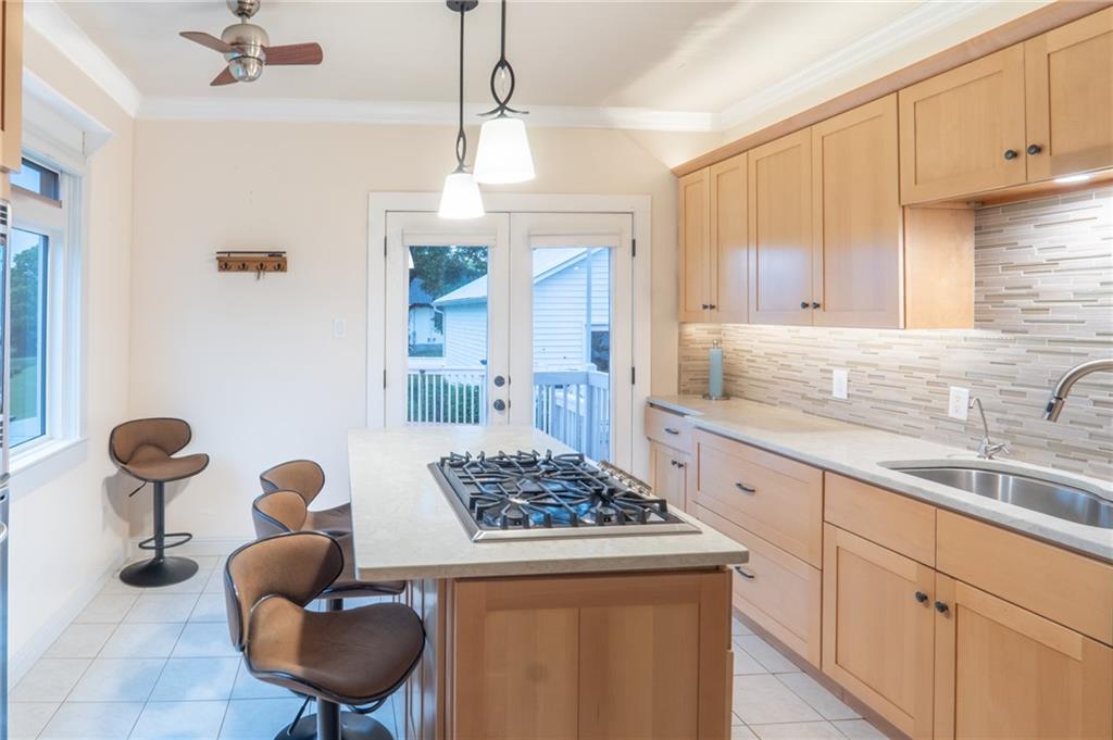 1815 Pickens Street Ball Ground, GA 30107 - Photo 1 of 38 a kitchen with stainless steel appliances granite countertop a sink a stove and a refrigerator