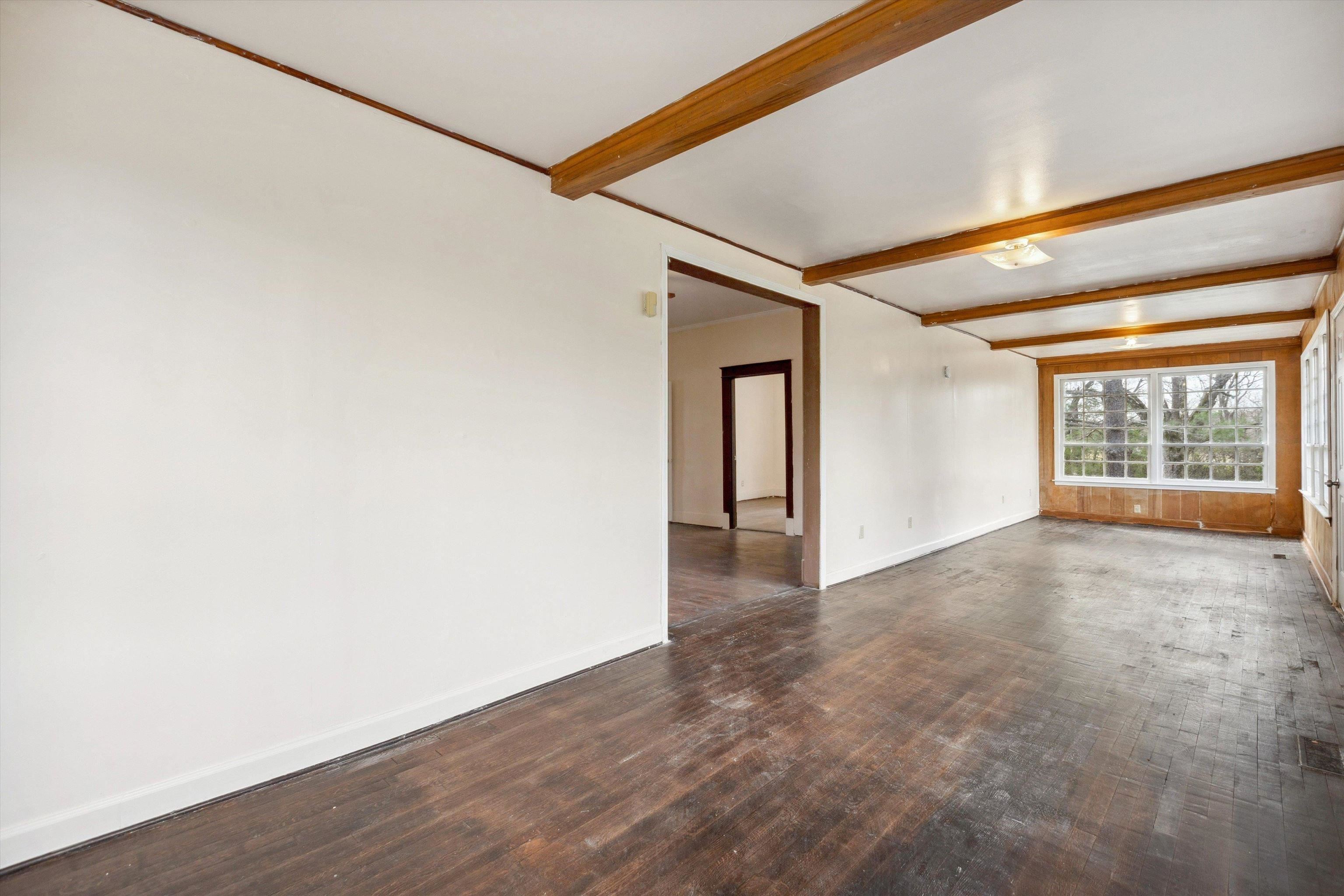 8457 East Kerrville Rosemark Road Millington, TN 38053 - Photo 11 of 32 Unfurnished room with dark wood-type flooring and beamed ceiling