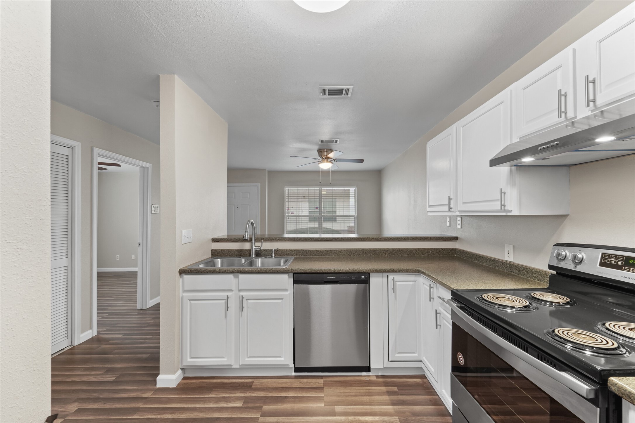 a kitchen with stainless steel appliances granite countertop a stove and a sink