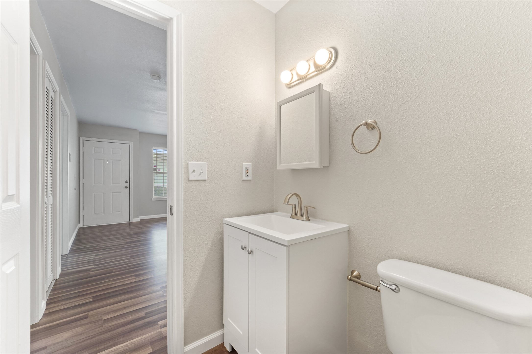 44426 Highway 290 Business, Unit 26 Prairie View, TX 77484 - Photo 10 of 12 a bathroom with a toilet a sink and mirror