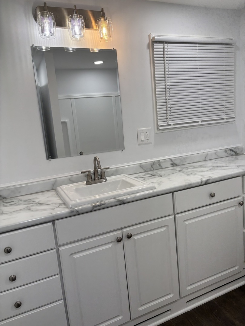 445 Lucile Avenue Elgin, IL 60120 - Photo 4 of 7 a bathroom with a granite countertop sink and a mirror
